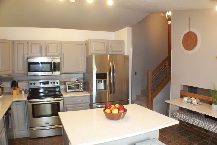 4241 Gloucester Road Roscoe, IL 61073 - Photo 5 of 50 a kitchen with stainless steel appliances granite countertop a sink a stove and a refrigerator