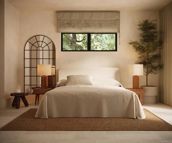 a bedroom with a large bed and a window