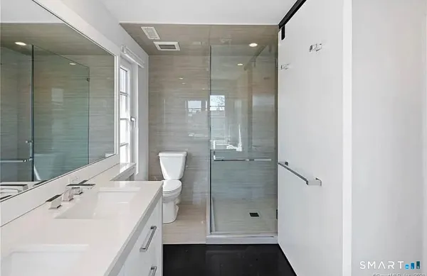 a bathroom with a shower sink and mirror