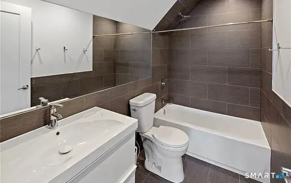 a bathroom with a sink a toilet and bathtub