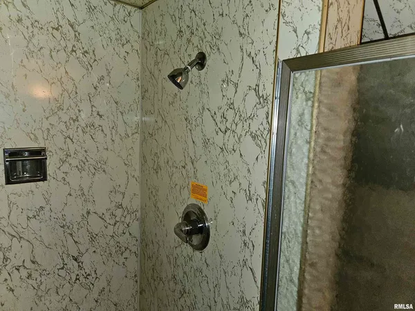 a bathroom with a granite countertop sink a toilet and a shower
