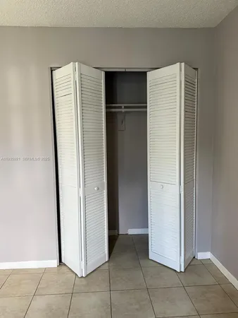 a room with a refrigerator and cabinets
