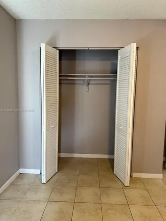 a view of room with refrigerator and window