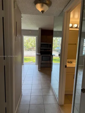 a kitchen with a refrigerator and a stove top oven