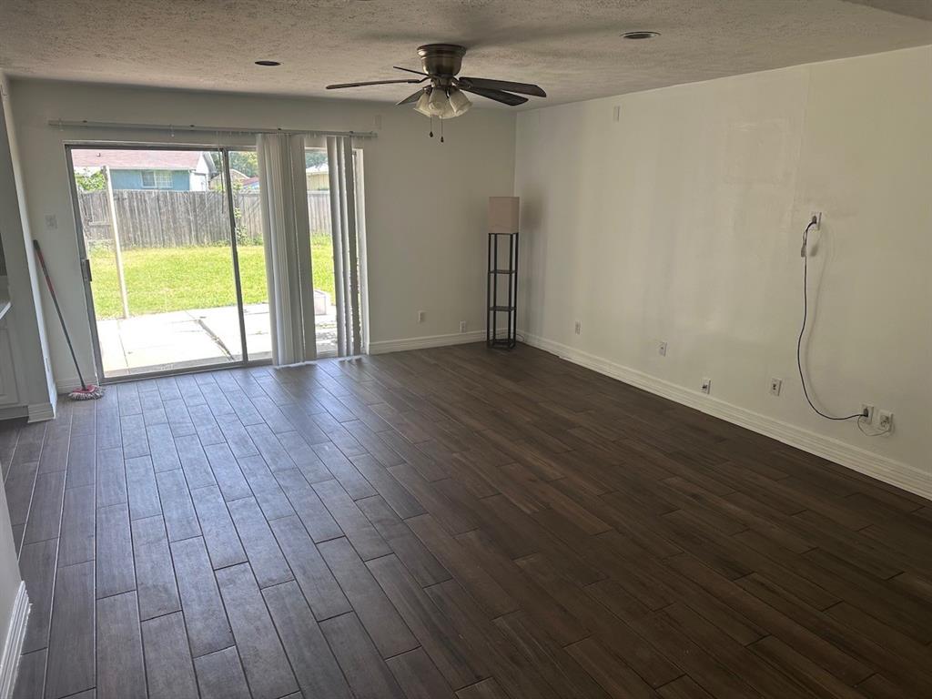 2103 Carlton Road Carrollton, TX 75007 - Photo 2 of 18 an empty room with wooden floor and windows