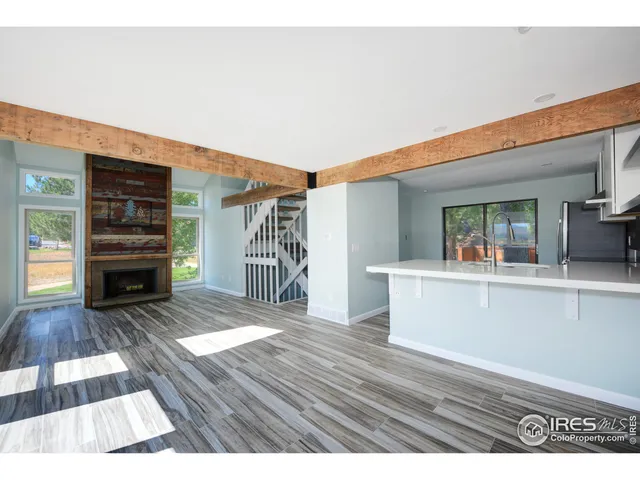 a view of living room and kitchen with wooden floor