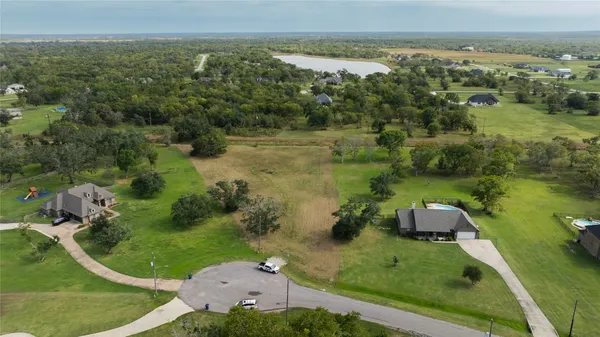 an aerial view of a golf course with a lake view