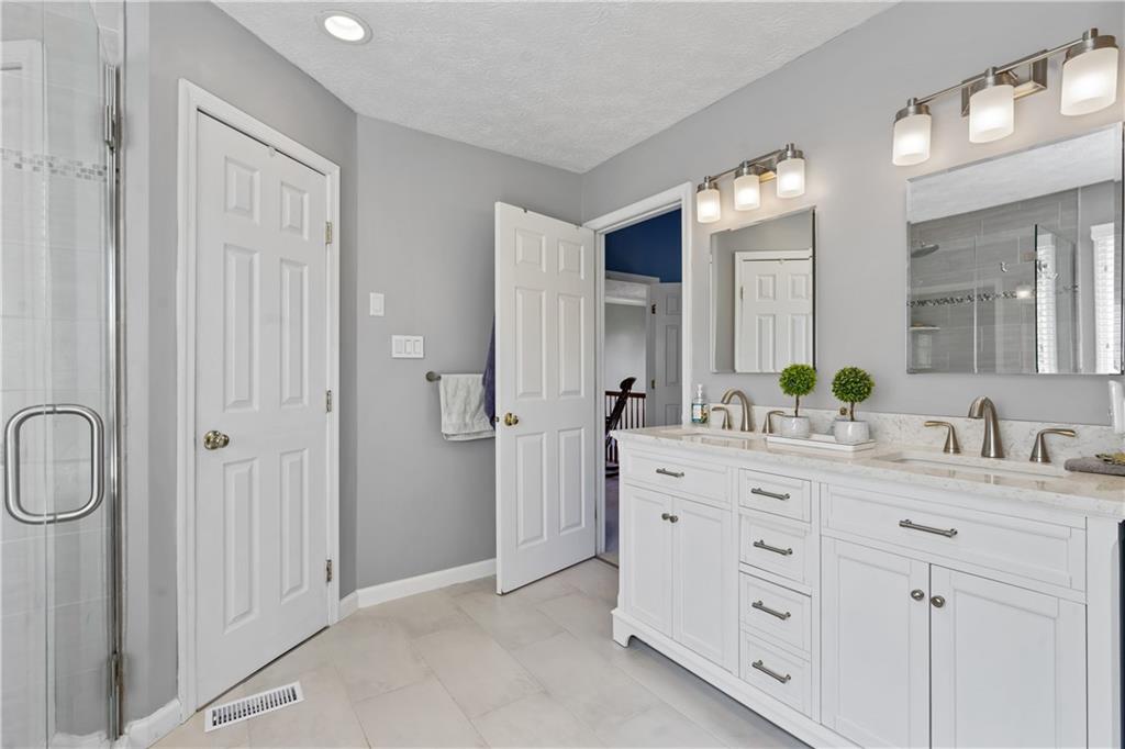 104 Field Club Circle McKees Rocks, PA 15136 - Photo 12 of 25 a spacious bathroom with a double vanity sink a mirror and a shower