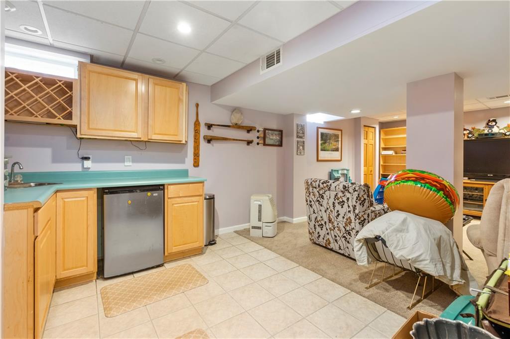 104 Field Club Circle McKees Rocks, PA 15136 - Photo 20 of 25 a bedroom with a bed and wooden cabinets