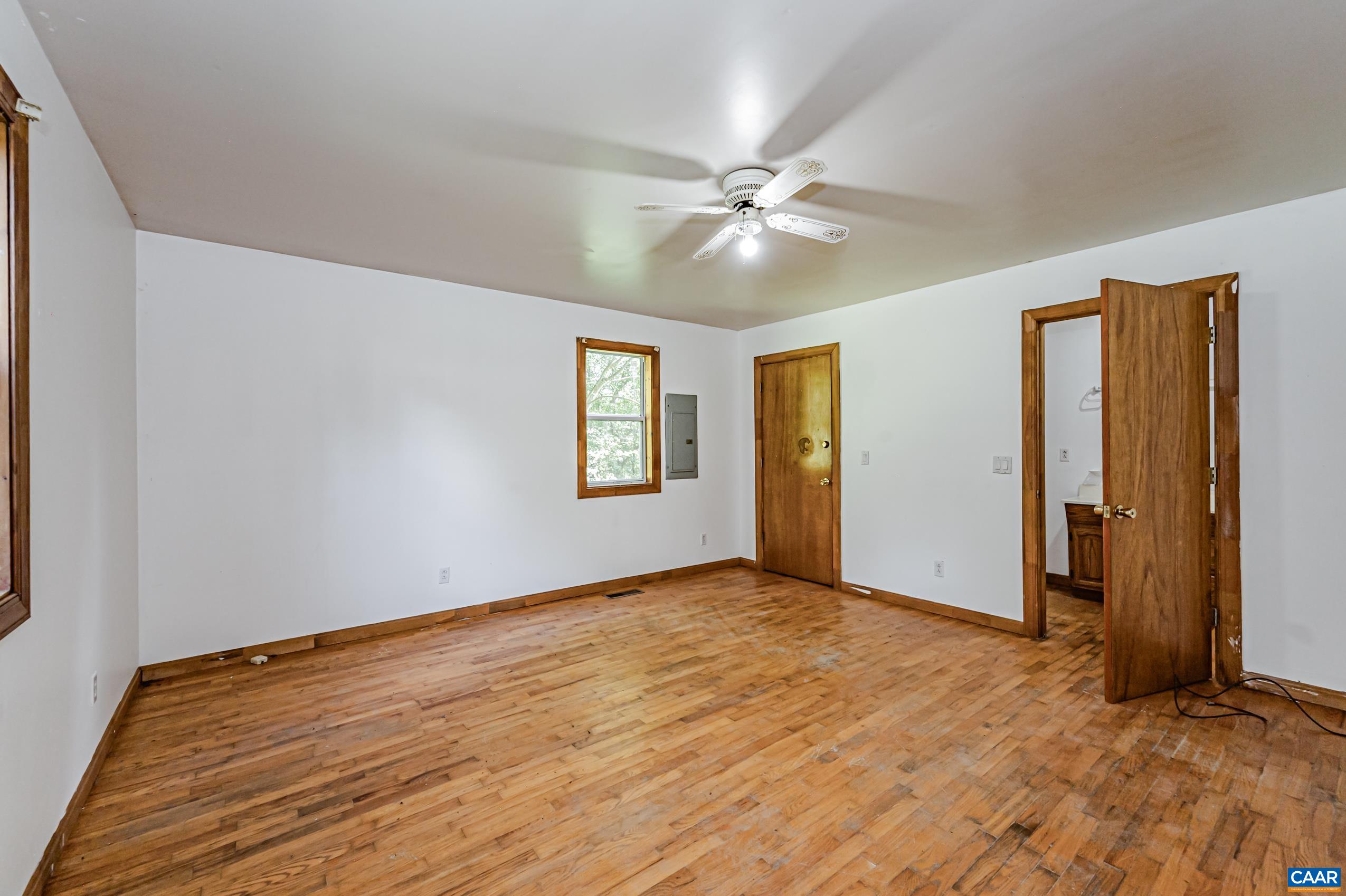 431 Graves Mill Road Madison, VA 22727 - Photo 13 of 26 a view of empty room with wooden floor and fan