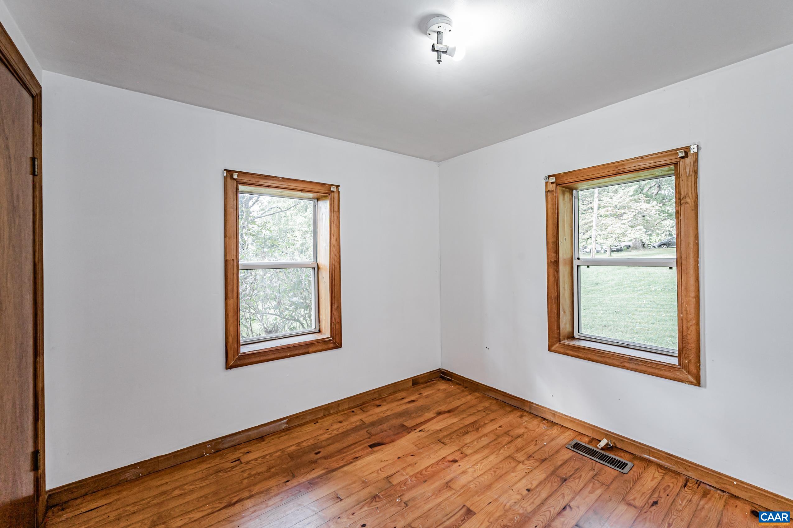 431 Graves Mill Road Madison, VA 22727 - Photo 15 of 26 a view of an empty room with wooden floor and a window