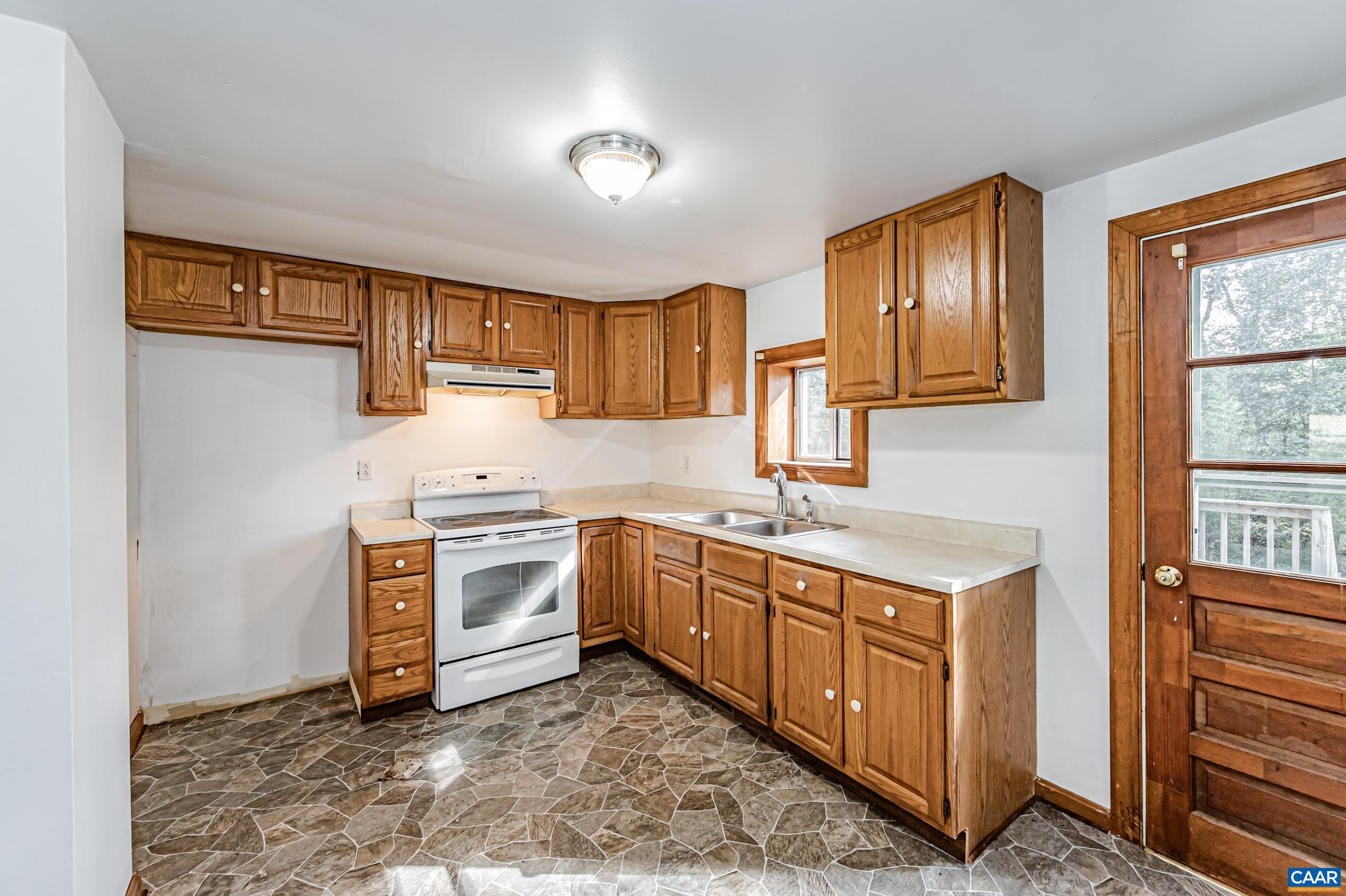 431 Graves Mill Road Madison, VA 22727 - Photo 5 of 26 a kitchen with a stove sink and cabinets