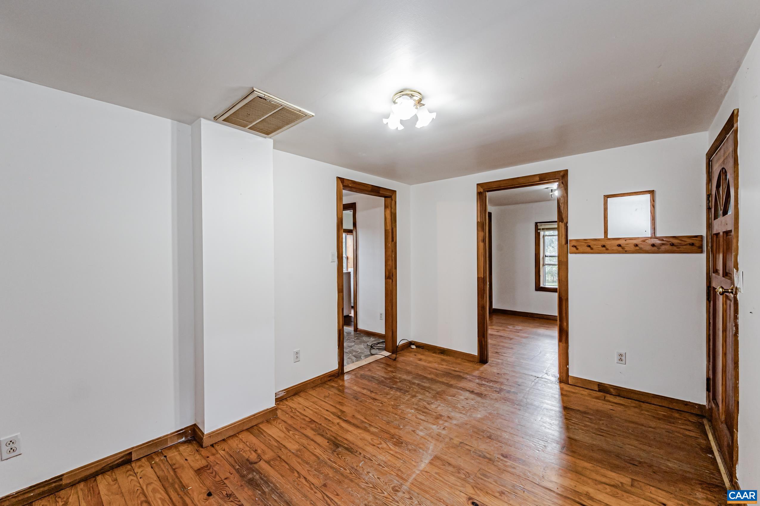 431 Graves Mill Road Madison, VA 22727 - Photo 7 of 26 a view of a livingroom with wooden floor and a kitchen