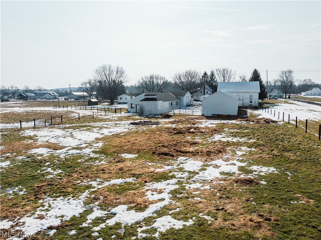 16350 Nauvoo Road Middlefield, OH 44062 - Photo 7 of 50 Snowy yard featuring a residential view and an outbuilding
