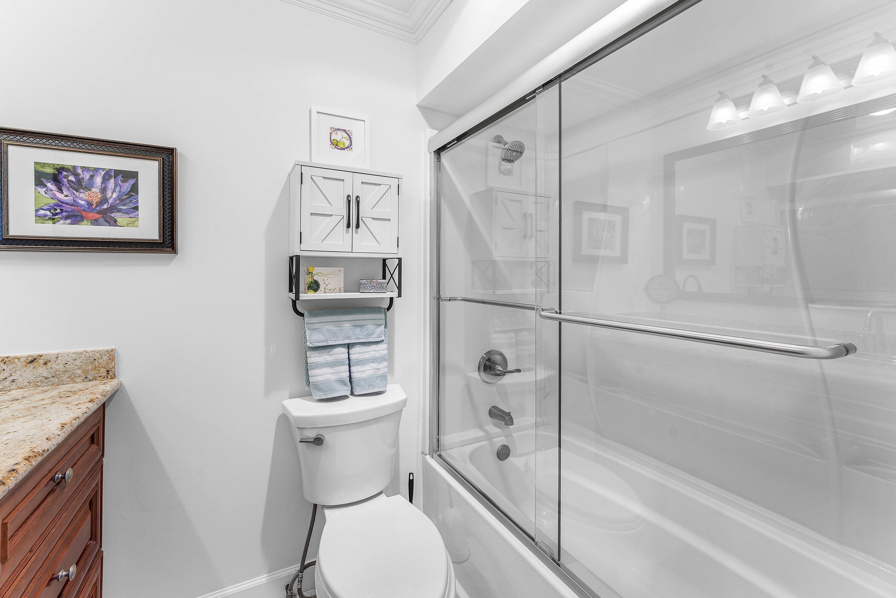 9179 Southeast Riverfront Terrace, Unit F Jupiter, FL 33469 - Photo 20 of 50 a bathroom with a toilet and a shower