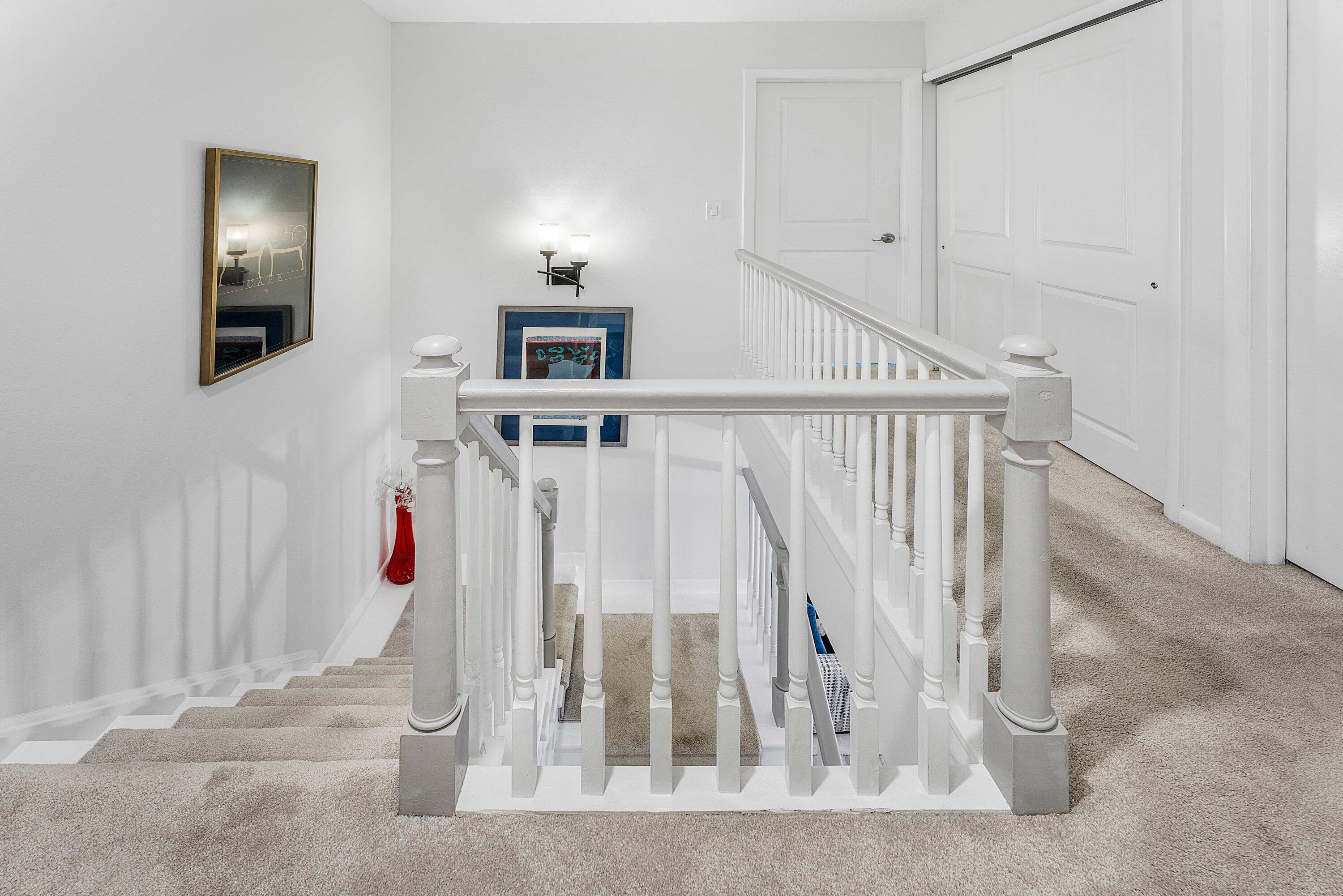 9179 Southeast Riverfront Terrace, Unit F Jupiter, FL 33469 - Photo 21 of 50 a view of a livingroom with wooden floor and staircase