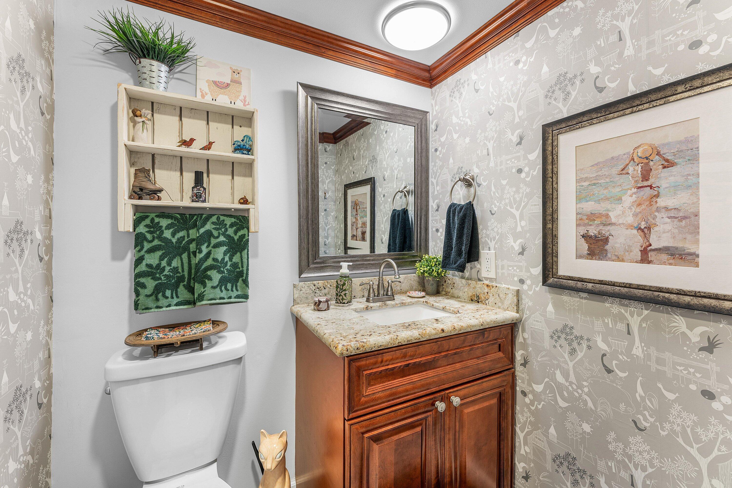 9179 Southeast Riverfront Terrace, Unit F Jupiter, FL 33469 - Photo 22 of 50 a bathroom with a toilet a sink and a mirror