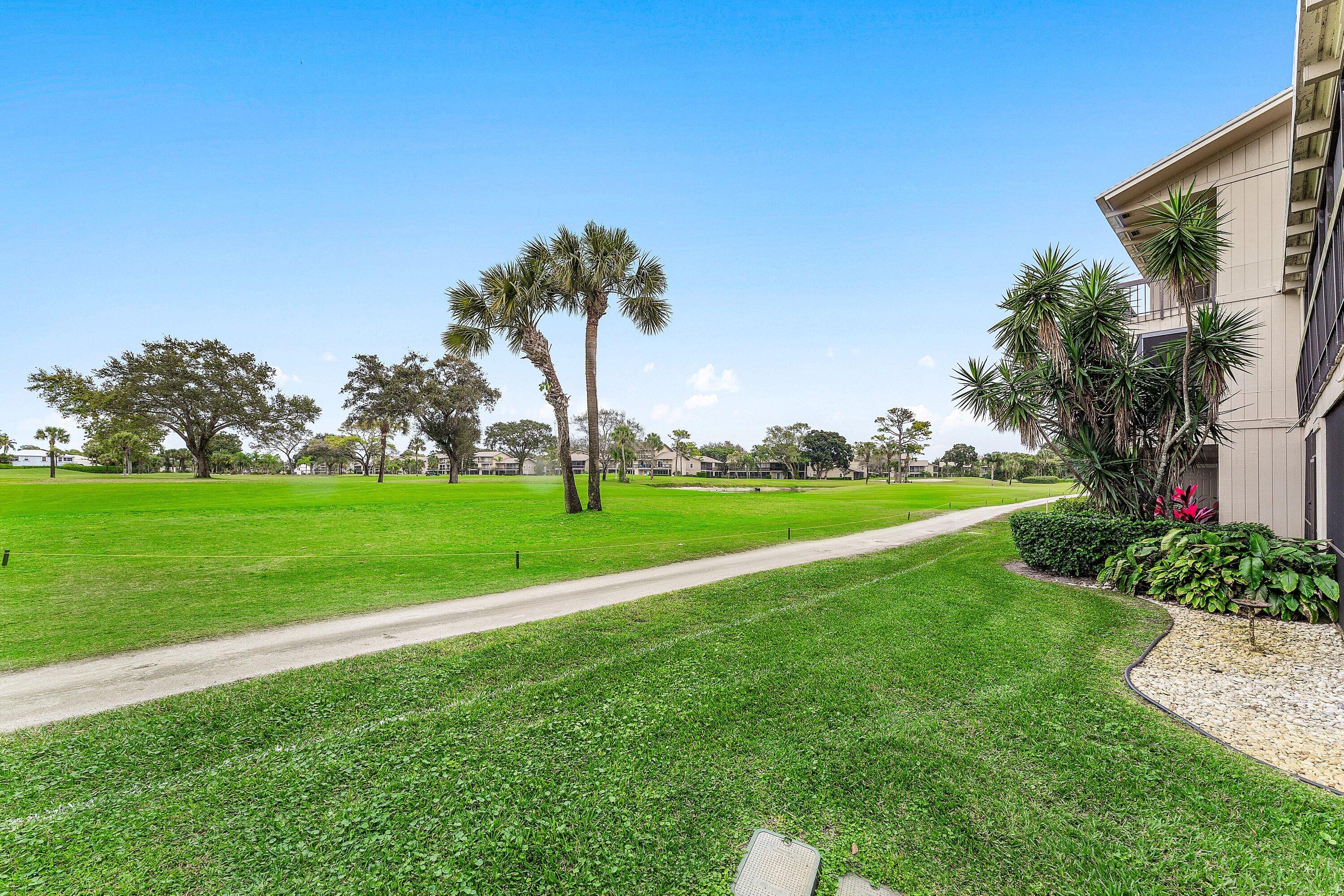 9179 Southeast Riverfront Terrace, Unit F Jupiter, FL 33469 - Photo 26 of 50 a view of a golf course