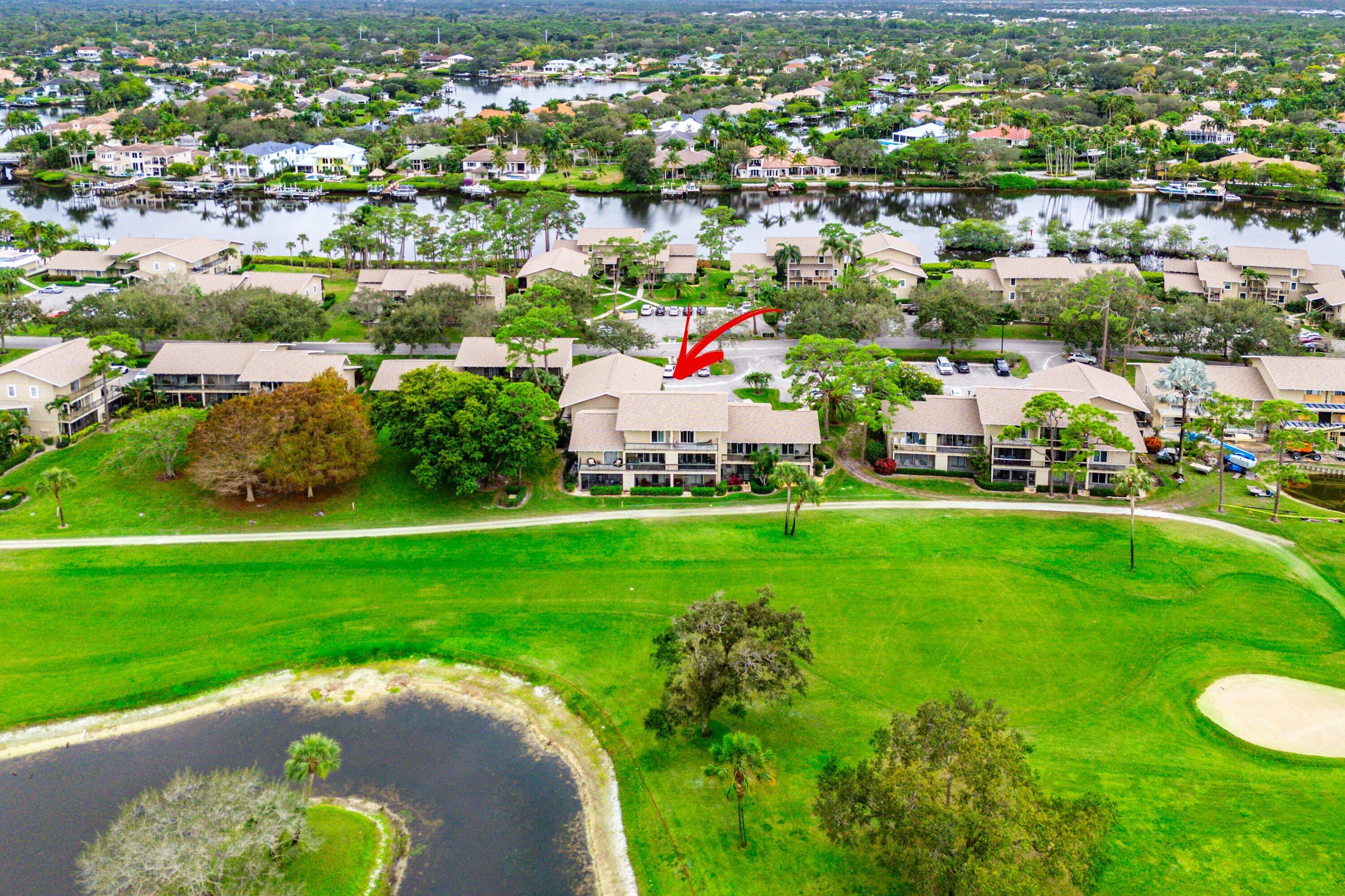 9179 Southeast Riverfront Terrace, Unit F Jupiter, FL 33469 - Photo 39 of 50 an aerial view of residential houses with outdoor space and trees