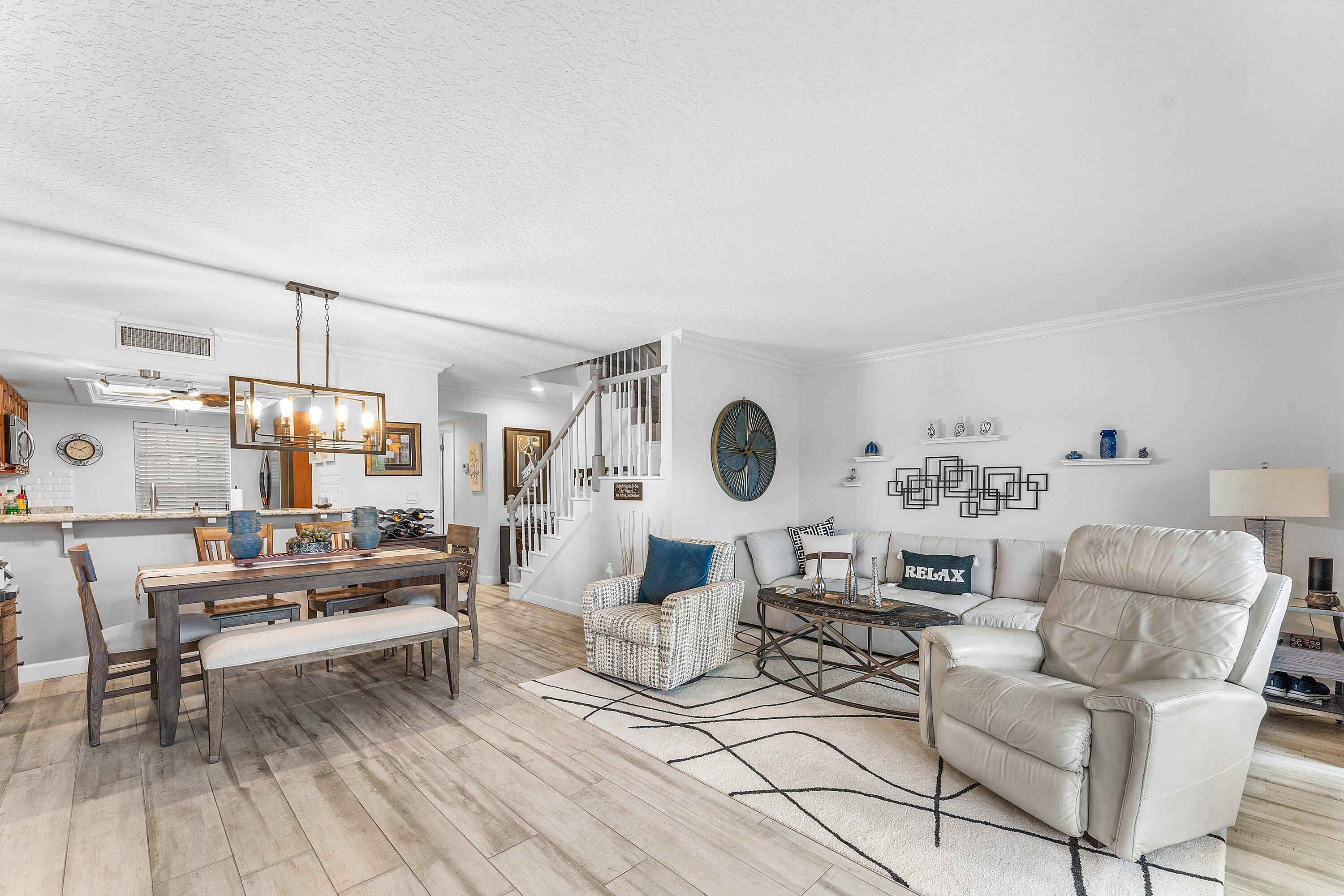 9179 Southeast Riverfront Terrace, Unit F Jupiter, FL 33469 - Photo 10 of 50 a living room with furniture and a wooden floor