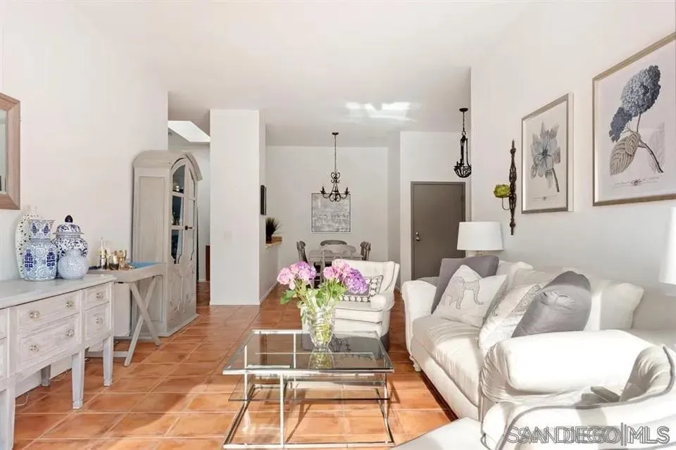 a living room with furniture and flowers