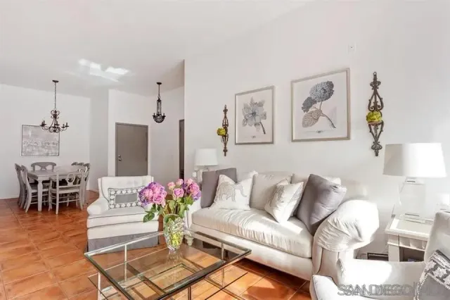 a living room with furniture and a chandelier