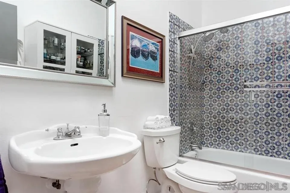 8328 Regents Road, Unit 3G San Diego, CA 92122 - Photo 7 of 8 a bathroom with a sink toilet and a mirror