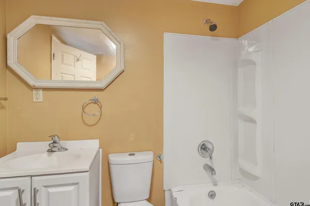 a bathroom with a sink toilet and tub