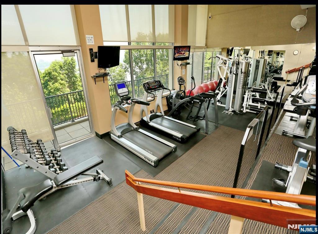 4 Horizon Road, Unit G20 Fort Lee, NJ 07024 - Photo 11 of 13 a room with gym equipment and a large window