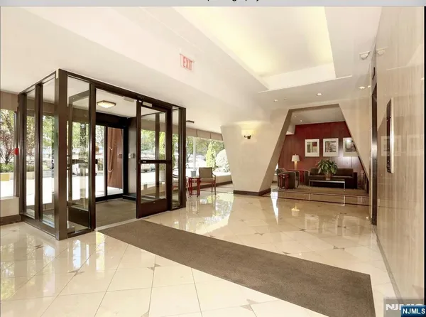 a lobby with furniture and floor to ceiling window