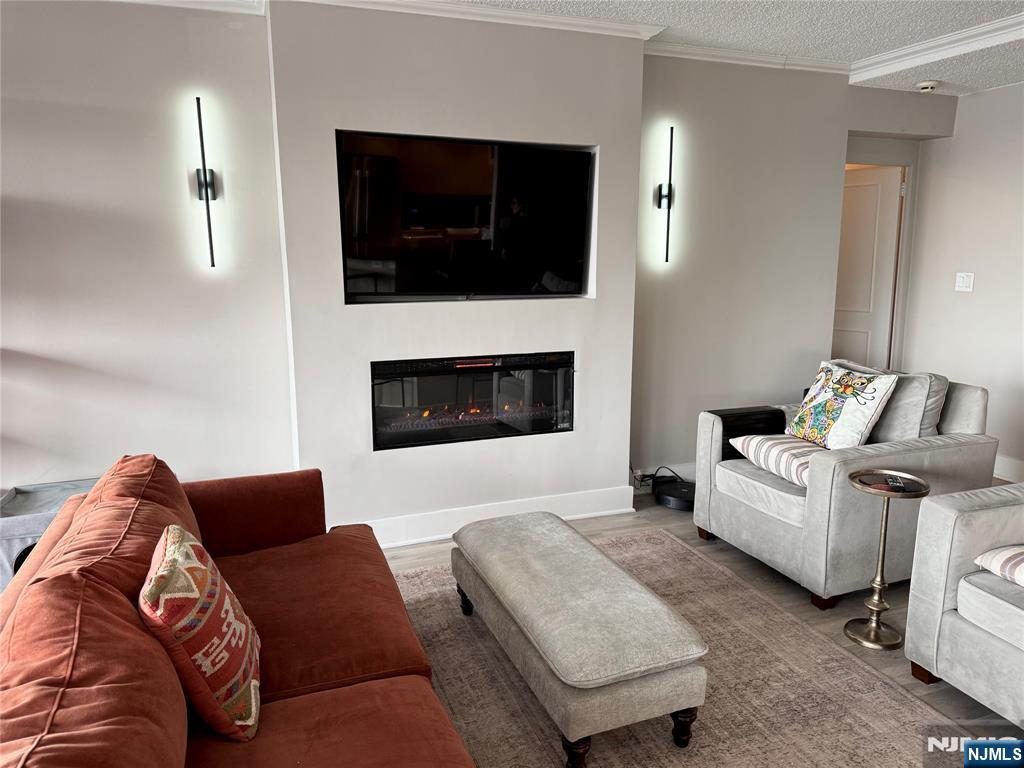 4 Horizon Road, Unit G20 Fort Lee, NJ 07024 - Photo 4 of 13 a living room with furniture and a flat screen tv