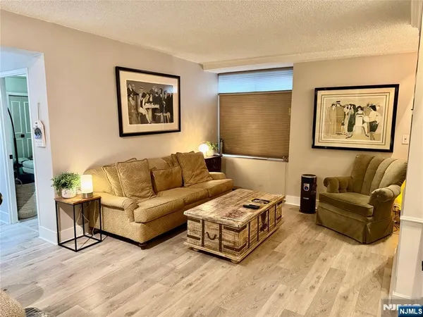 a living room with couches and painting on the wall