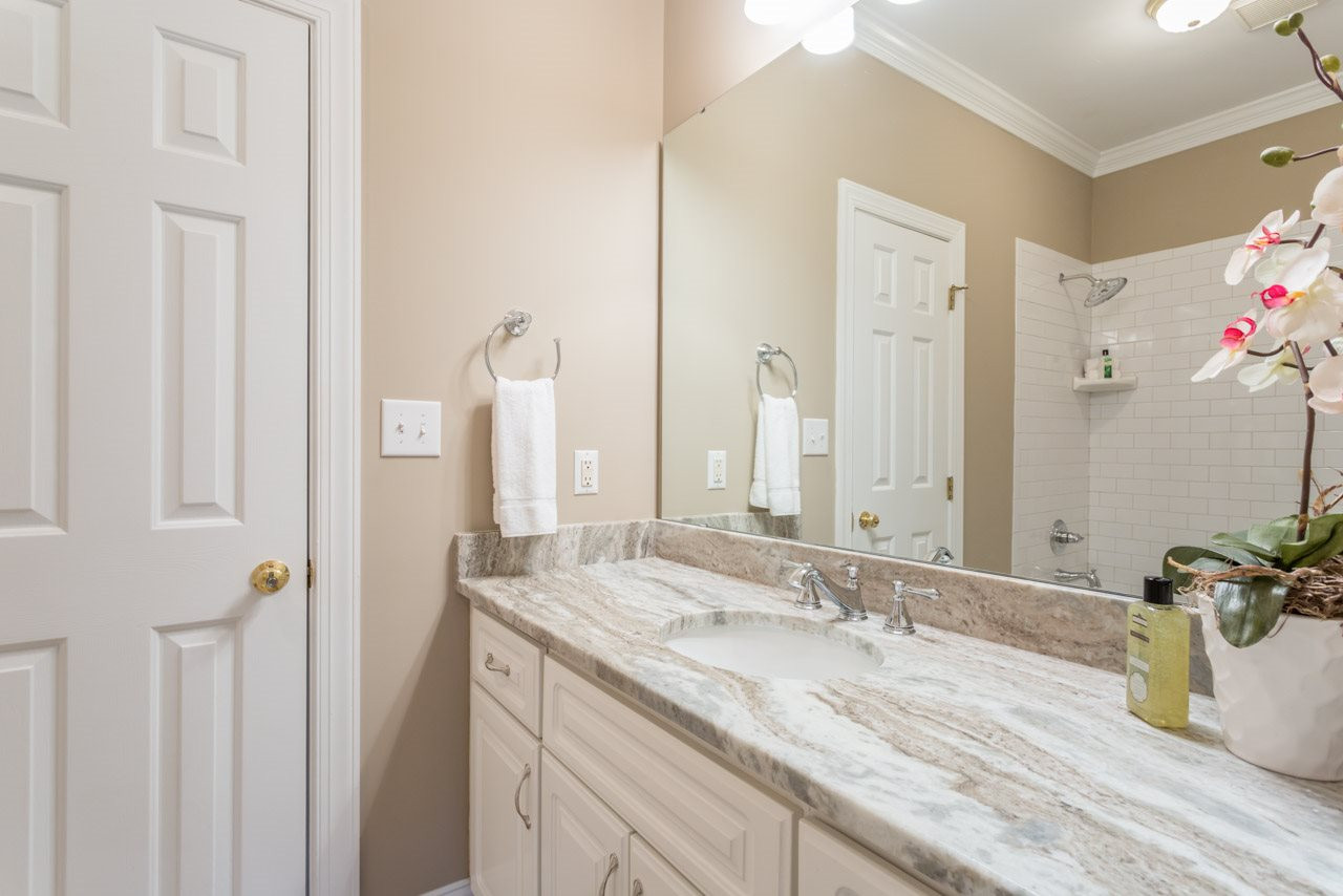 8704 Carriage Tour Lane Raleigh, NC 27615 - Photo 20 of 25 New granite and tile in this first floor guest bath. Guest bath
