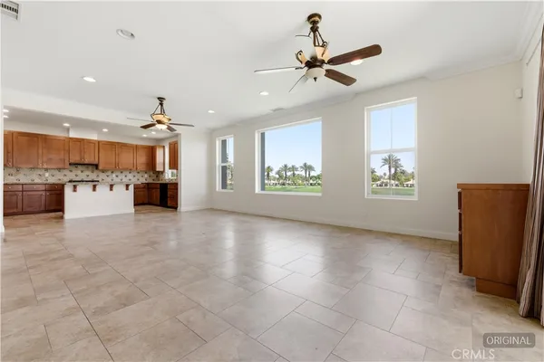 a living room with furniture kitchen view and a window