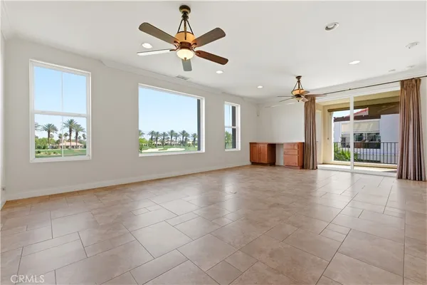 an empty room with closet and ceiling fan