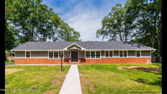 a front view of a house with a yard table and chairs