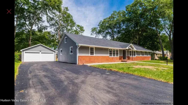 a front view of a house with yard and green space