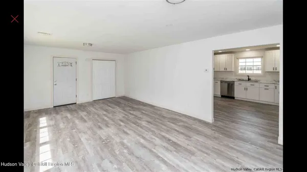a view of a kitchen with a sink and dishwasher a refrigerator with wooden floor