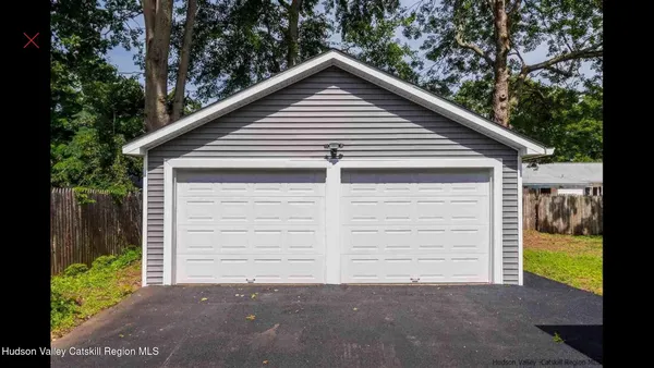 a view of a house with a yard and garage