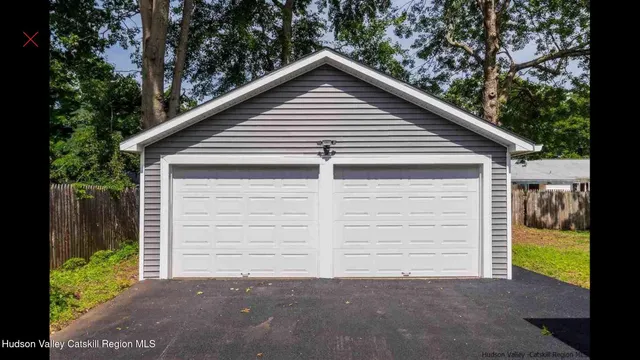 a view of a house with a yard and garage