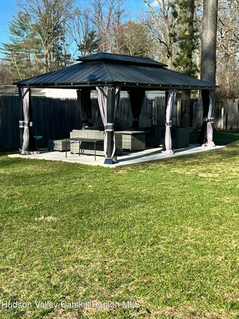 a view of a house with a yard and a garden