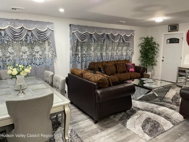 a living room with furniture and a mirror
