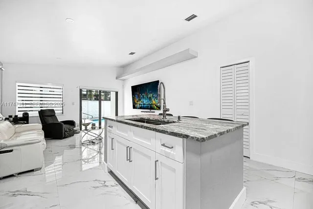 a view of a kitchen with a sink and cabinets