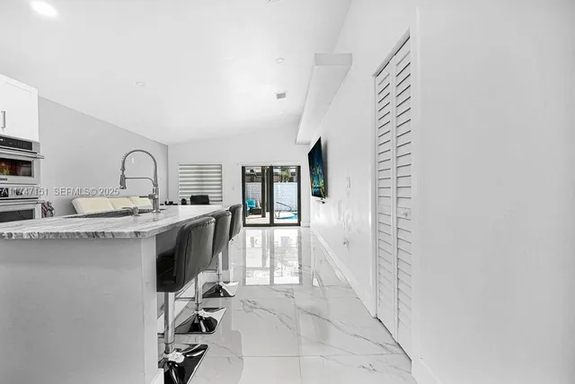 a living room with furniture a window and flat screen tv