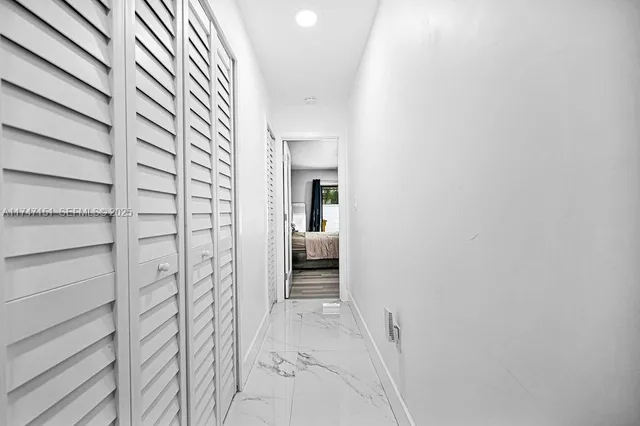 a bedroom with a bed wooden floor and window