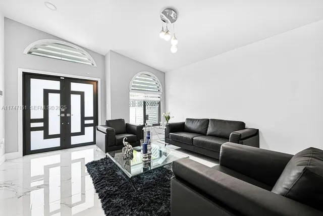 a living room with furniture and a large window