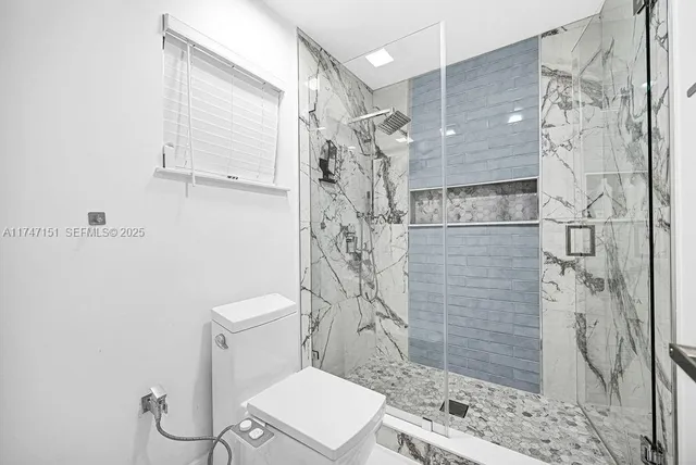 a bedroom with bed and a window