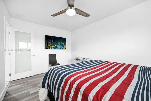 a bedroom with a bed dresser and a window