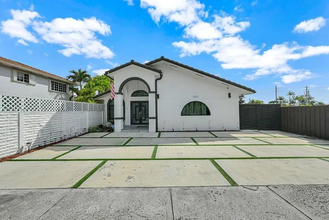 a view of a white house with a yard