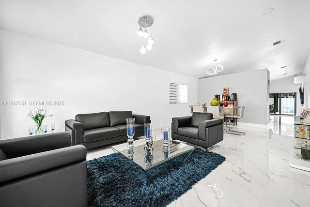 a view of a dining room with furniture and a chandelier
